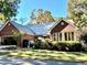 Brick house with metal roof and attached garage at 3530 Dahlonega Hwy, Cumming, GA 30028