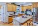 Modern kitchen with stainless steel appliances and light wood cabinets at 3530 Dahlonega Hwy, Cumming, GA 30028