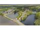 Scenic aerial view showcasing a lakeside community with lush greenery, walking trails, tennis courts, and beautiful surrounding lakes at 6329 Edgewater Cv, Fairburn, GA 30213