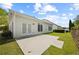 Exterior view showcasing a patio, backyard, and the home's architectural features at 6329 Edgewater Cv, Fairburn, GA 30213