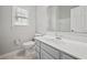 Bathroom features tiled flooring, a toilet, and a vanity with grey cabinets at 6329 Edgewater Cv, Fairburn, GA 30213