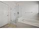 Beautiful bathroom showcasing a glass enclosed shower, soaking tub, and tiled floors at 6329 Edgewater Cv, Fairburn, GA 30213