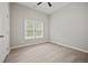 Bright bedroom featuring luxury vinyl plank flooring, a window, and neutral walls at 6329 Edgewater Cv, Fairburn, GA 30213