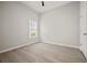 Bright bedroom featuring luxury vinyl plank flooring, a window, and neutral walls at 6329 Edgewater Cv, Fairburn, GA 30213