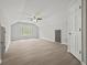 Large bonus room with luxury vinyl plank flooring, high ceilings, and natural light at 6329 Edgewater Cv, Fairburn, GA 30213