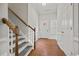 Bright foyer features hardwood floors, white wainscoting, and staircase leading to the upper level at 6329 Edgewater Cv, Fairburn, GA 30213
