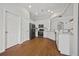 Well-lit kitchen features white cabinets, stainless steel appliances, granite countertops, and hardwood floors at 6329 Edgewater Cv, Fairburn, GA 30213