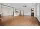 Open-concept living room with hardwood floors, fireplace, neutral paint, and open access to the kitchen at 6329 Edgewater Cv, Fairburn, GA 30213