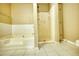 Bathroom featuring a shower, tub with tile surround, and tiled flooring at 6693 Villa Ct # 6693, Lithonia, GA 30038