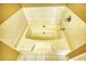 Bathroom featuring a tub with tile surround and chrome fixtures at 6693 Villa Ct # 6693, Lithonia, GA 30038