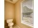 Cozy half bath with toilet, window, and tiled floor at 6693 Villa Ct # 6693, Lithonia, GA 30038