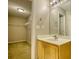Bathroom featuring a wood vanity, sink, mirror, and walk-in closet with wire shelving at 6693 Villa Ct # 6693, Lithonia, GA 30038