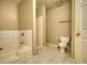Bathroom featuring a shower, tub with tile surround, tiled flooring and toilet at 6693 Villa Ct # 6693, Lithonia, GA 30038