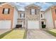 Charming townhome with a stone facade and a one-car garage and well maintained front lawn at 6693 Villa Ct # 6693, Lithonia, GA 30038