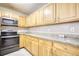 Kitchen with stainless steel appliances, granite countertops and wood cabinets at 6693 Villa Ct # 6693, Lithonia, GA 30038