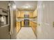 Spacious kitchen featuring wood cabinets, stainless steel appliances, and light countertops at 6693 Villa Ct # 6693, Lithonia, GA 30038
