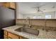 Kitchen sink with stainless steel faucet and a view into the living room at 6693 Villa Ct # 6693, Lithonia, GA 30038