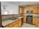 Open floor plan featuring the kitchen with wood cabinets and stainless steel appliances at 6693 Villa Ct # 6693, Lithonia, GA 30038