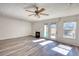 Bright living room with new wood flooring, fireplace, ceiling fan, and lots of natural light at 6693 Villa Ct # 6693, Lithonia, GA 30038