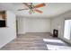 Open concept living room features luxury flooring, fireplace, and ceiling fan at 6693 Villa Ct # 6693, Lithonia, GA 30038
