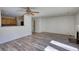Wide angle view of the living room showing luxury flooring and flow into kitchen at 6693 Villa Ct # 6693, Lithonia, GA 30038