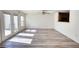 Spacious living room featuring hardwood floors and glass doors to the backyard at 6693 Villa Ct # 6693, Lithonia, GA 30038
