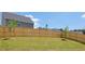 Large backyard featuring a wooden fence and lush green grass at 134 Oakchase Park Ln, Hampton, GA 30228