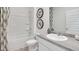 Clean and modern bathroom featuring a shower-tub combo with stylish fixtures at 134 Oakchase Park Ln, Hampton, GA 30228