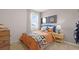 Cozy bedroom featuring a bed with a sports-themed comforter and neutral walls at 134 Oakchase Park Ln, Hampton, GA 30228