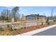 Stone entrance to Oakchase at Hampton with manicured landscaping at 134 Oakchase Park Ln, Hampton, GA 30228