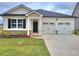 Charming one-story home with a two-car garage and well-manicured lawn at 134 Oakchase Park Ln, Hampton, GA 30228