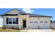 Charming single-story home with a two-car garage, brick accents, and a well-manicured lawn at 134 Oakchase Park Ln, Hampton, GA 30228