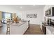 Modern kitchen with a large island, stainless steel appliances, and an open view to the living room at 134 Oakchase Park Ln, Hampton, GA 30228
