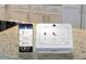 Smart home control panel on granite countertops, integrated with security, thermostat, and garage door systems at 134 Oakchase Park Ln, Hampton, GA 30228