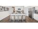 Stylish kitchen featuring an island with seating, granite countertops, stainless steel appliances, and hardwood floors at 134 Oakchase Park Ln, Hampton, GA 30228