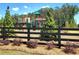 Community playground area surrounded by trees and a black fence at 134 Oakchase Park Ln, Hampton, GA 30228