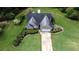 Aerial view of a home with manicured lawn, mature trees, and a long driveway at 7030 Valley Landing Ct, Cumming, GA 30041