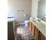 Bathroom featuring a single vanity with a large mirror, tiled flooring, and neutral walls at 7030 Valley Landing Ct, Cumming, GA 30041