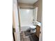 Neutral bathroom featuring a shower-tub combo, toilet, and tile flooring at 7030 Valley Landing Ct, Cumming, GA 30041