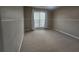 Bedroom featuring neutral walls, plush carpet flooring and bright window at 7030 Valley Landing Ct, Cumming, GA 30041