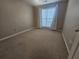 Cozy bedroom with neutral walls and plush carpet flooring illuminated by natural light at 7030 Valley Landing Ct, Cumming, GA 30041