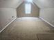Bonus room featuring neutral walls, plush carpet flooring and bright window at 7030 Valley Landing Ct, Cumming, GA 30041