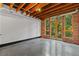 Bright and airy living room with exposed brick wall and a large window with green trees at 319 Atlanta Se St # 317, Marietta, GA 30060