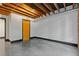 Bright room with white walls, exposed beams, and black trim, featuring a natural wood door at 319 Atlanta Se St # 317, Marietta, GA 30060