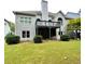 Backyard featuring a spacious lawn, second-story deck, and lush green landscaping at 306 Mountain Laurel Walk, Canton, GA 30114