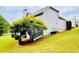 Spacious backyard with lush green grass, mature trees, and access to a deck at 306 Mountain Laurel Walk, Canton, GA 30114