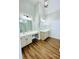 Bathroom with double sink vanity, wood look floor, and modern lighting at 306 Mountain Laurel Walk, Canton, GA 30114
