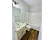 Bright bathroom featuring a tub-shower combo, vanity with sink, and wood-look flooring at 306 Mountain Laurel Walk, Canton, GA 30114