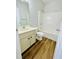 Bright bathroom featuring a tub-shower combo, vanity with sink, and wood-look flooring at 306 Mountain Laurel Walk, Canton, GA 30114