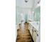 Bright bathroom features double vanities, wood-look floors, and modern fixtures at 306 Mountain Laurel Walk, Canton, GA 30114